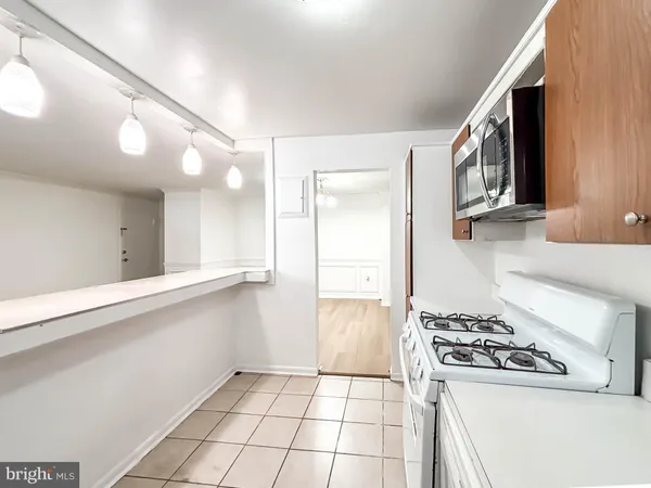 a kitchen with a stove a sink and a refrigerator