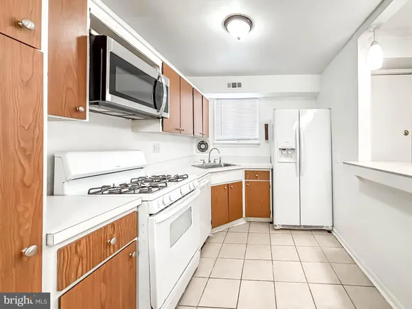 a kitchen with a stove a sink and a refrigerator