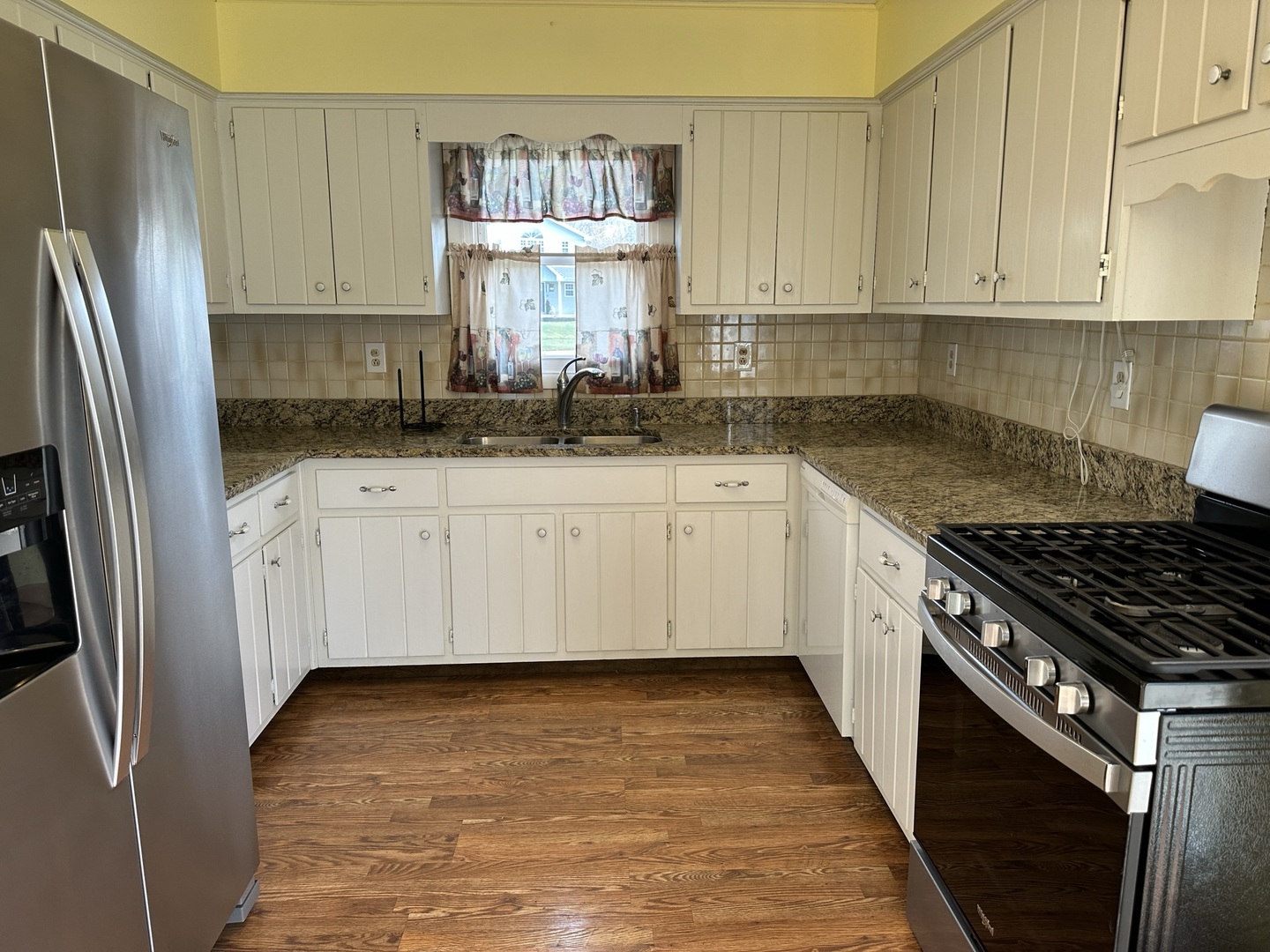 320 Stonegate Road New Lenox, IL 60451 - Photo 11 of 31 a kitchen with stainless steel appliances granite countertop a stove a sink and a refrigerator