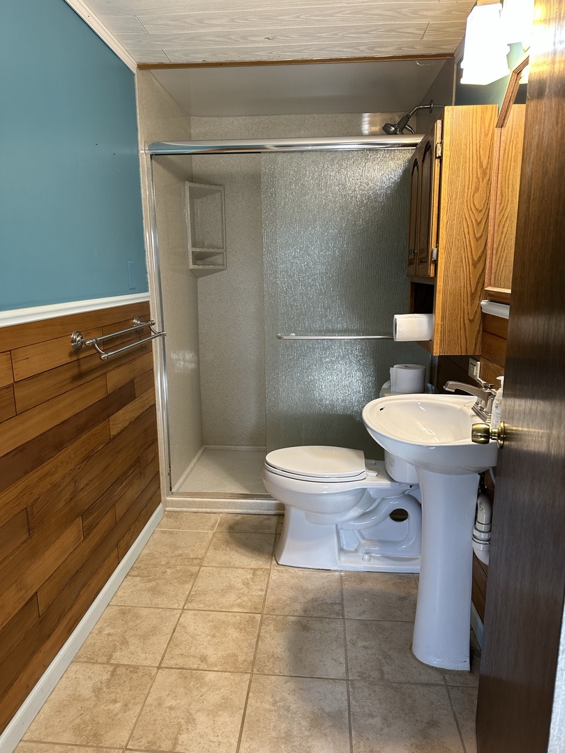 320 Stonegate Road New Lenox, IL 60451 - Photo 22 of 31 a bathroom with a sink a toilet and shower