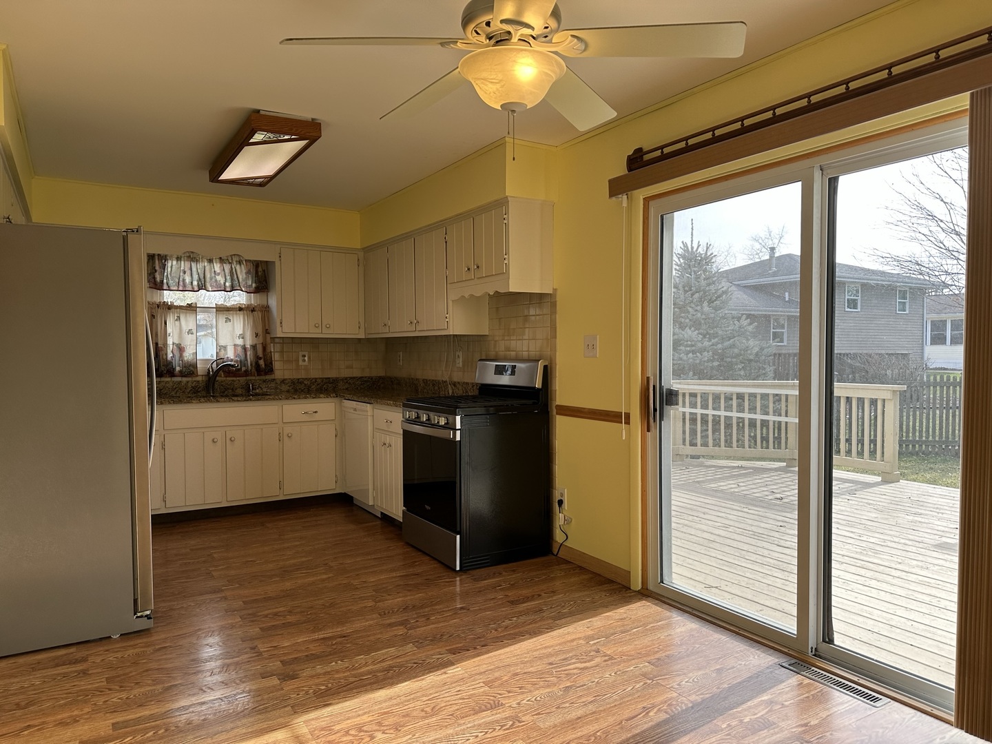 320 Stonegate Road New Lenox, IL 60451 - Photo 9 of 31 a kitchen with stainless steel appliances a sink a counter top space cabinets and a wooden floor