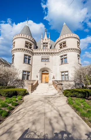 a large white building with a clock on the side of it