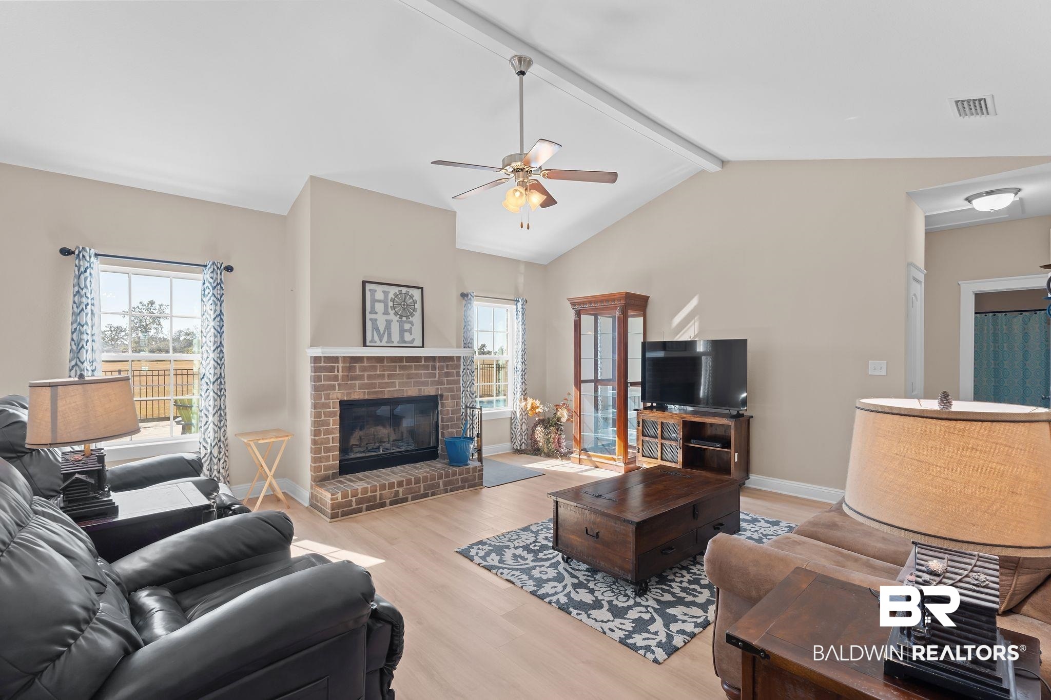 28980 Comstock Road Elberta, AL 36530 - Photo 3 of 38 Living area with light wood-type flooring, a brick fireplace, and a ceiling fan