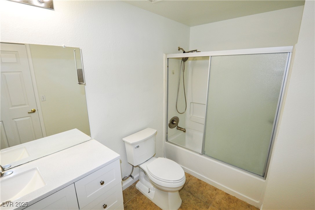 231 West Horizon Ridge Parkway, Unit 1113 Henderson, NV 89012 - Photo 13 of 23 Bathroom featuring shower / bath combination with glass door, vanity, and tile patterned flooring