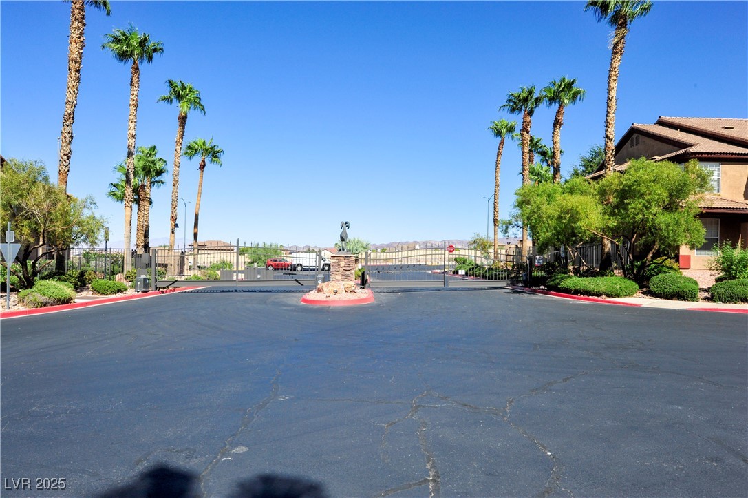 231 West Horizon Ridge Parkway, Unit 1113 Henderson, NV 89012 - Photo 23 of 23 View of asphalt road featuring a gate, a gated entry, and curbs