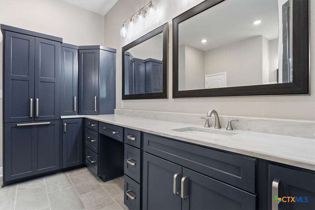 14308 Fm 2904 Temple, TX 76501 - Photo 22 of 45 a bathroom with a granite countertop sink and a mirror