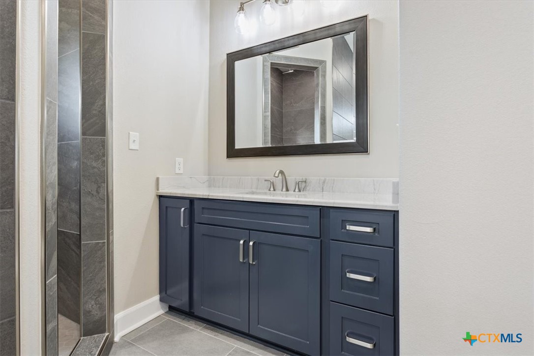 14308 Fm 2904 Temple, TX 76501 - Photo 23 of 45 a bathroom with a sink vanity and mirror
