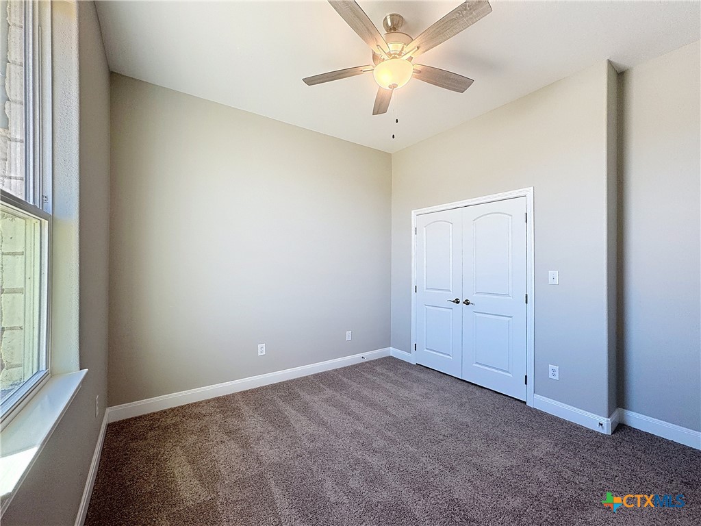 14308 Fm 2904 Temple, TX 76501 - Photo 29 of 45 an empty room with a ceiling fan and a window