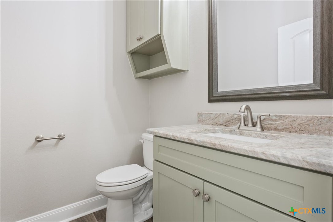 14308 Fm 2904 Temple, TX 76501 - Photo 32 of 45 a bathroom with a granite countertop toilet sink and mirror