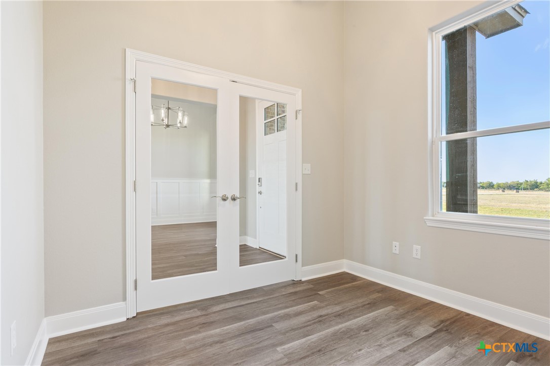 14308 Fm 2904 Temple, TX 76501 - Photo 9 of 45 an empty room with wooden floor and windows