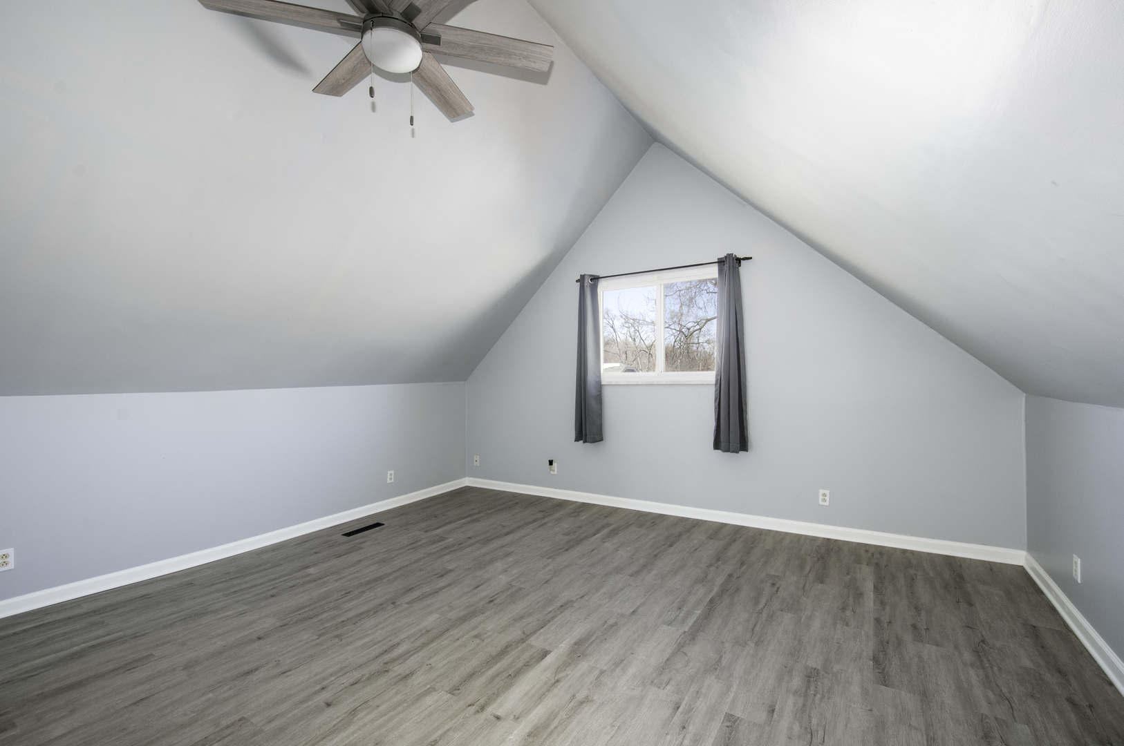 14526 Ridgeway Avenue Midlothian, IL 60445 - Photo 12 of 17 an empty room with wooden floor fan and windows