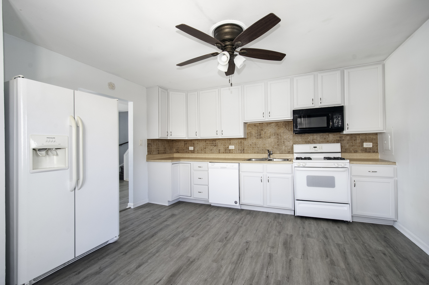 14526 Ridgeway Avenue Midlothian, IL 60445 - Photo 5 of 17 a kitchen with white cabinets and white appliances