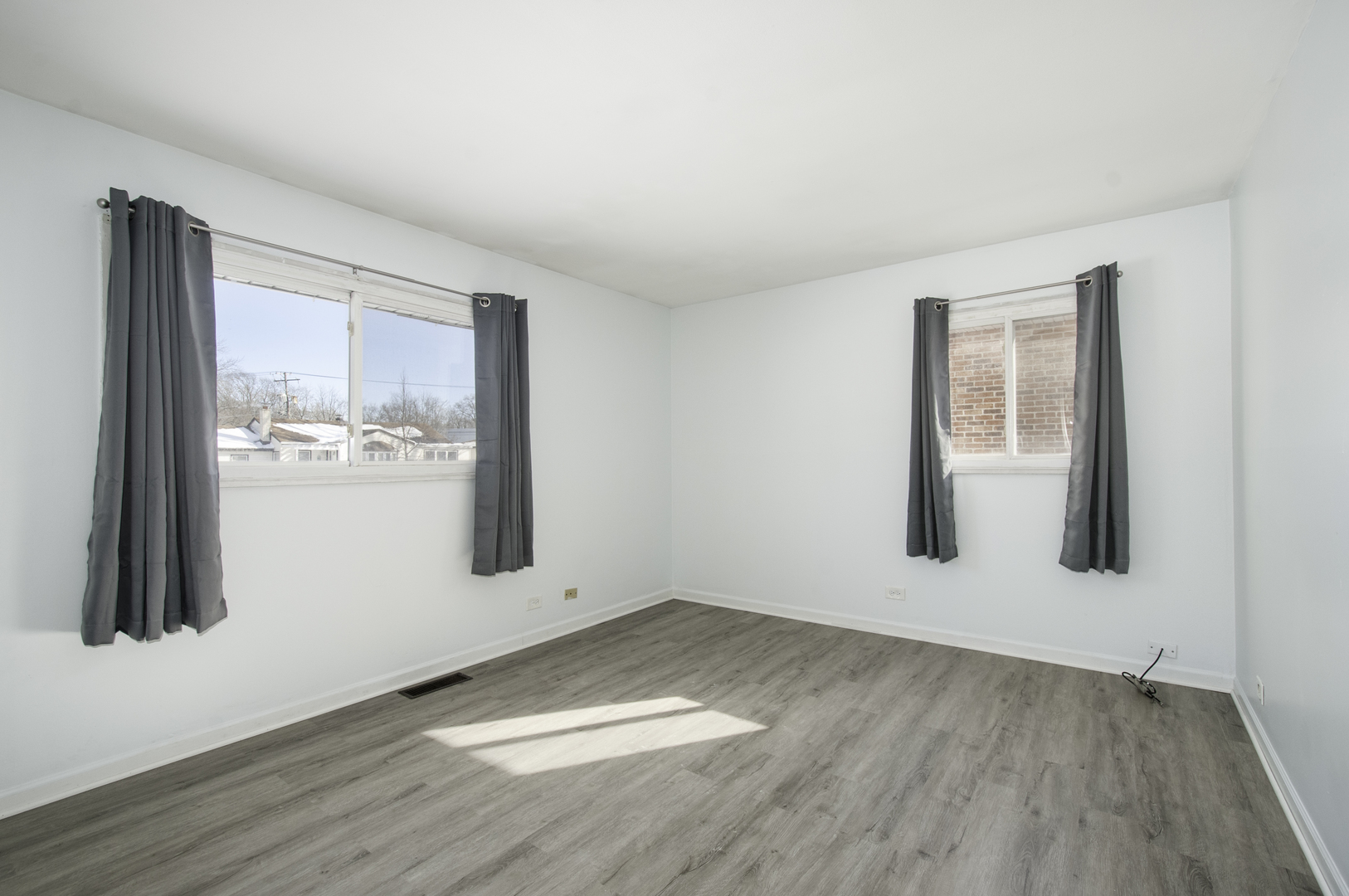 14526 Ridgeway Avenue Midlothian, IL 60445 - Photo 7 of 17 an empty room with wooden floor and windows
