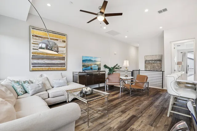 a living room with furniture a dining table and a piano