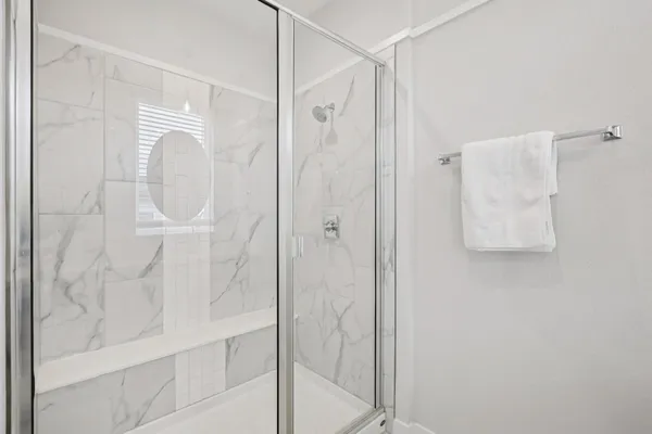 a bathroom with a glass shower door