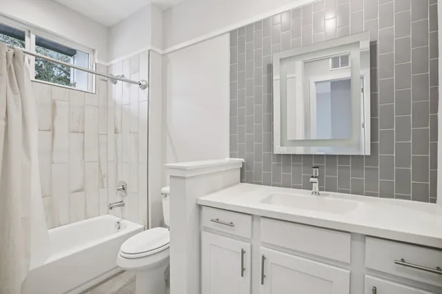 a bathroom with a sink toilet and shower