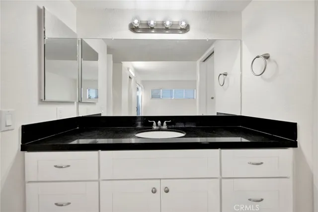 a bath room with a sink and a mirror
