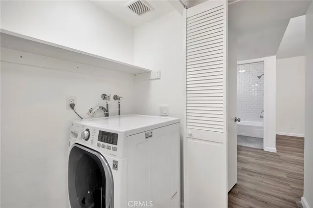 a view of a room with wooden floor