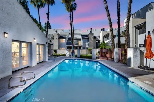 a swimming pool with outdoor seating and yard