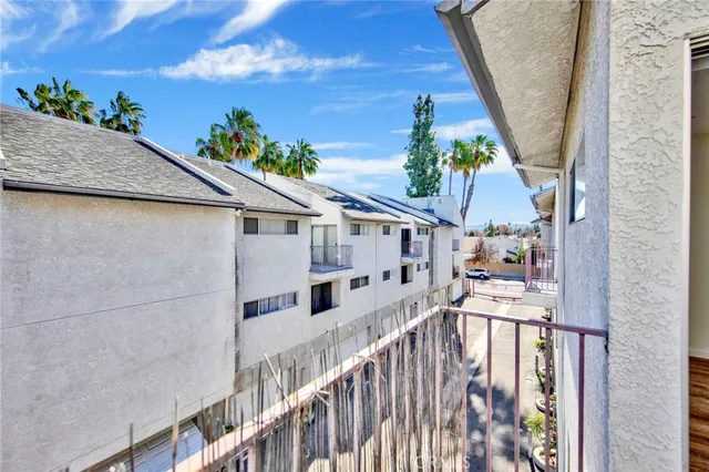 a balcony with furniture and a potted plant