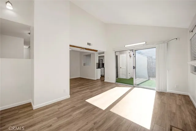 a view of an empty room and wooden floor