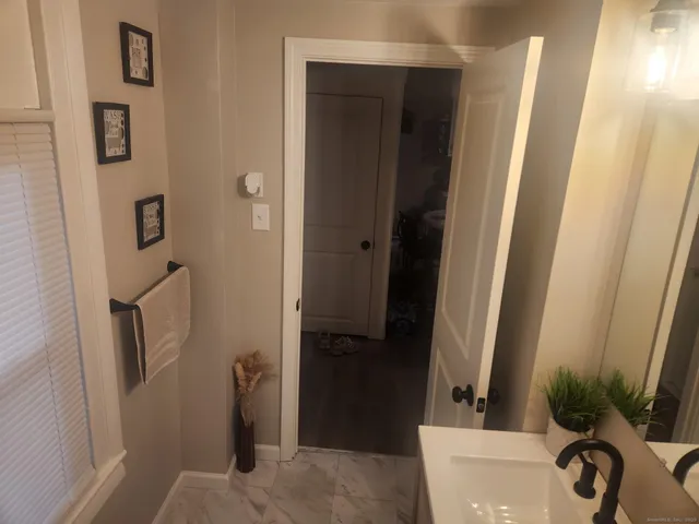a view of a bathroom from a hallway