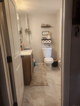 a bathroom with a toilet a sink and a shower