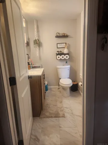 a bathroom with a toilet a sink and a shower