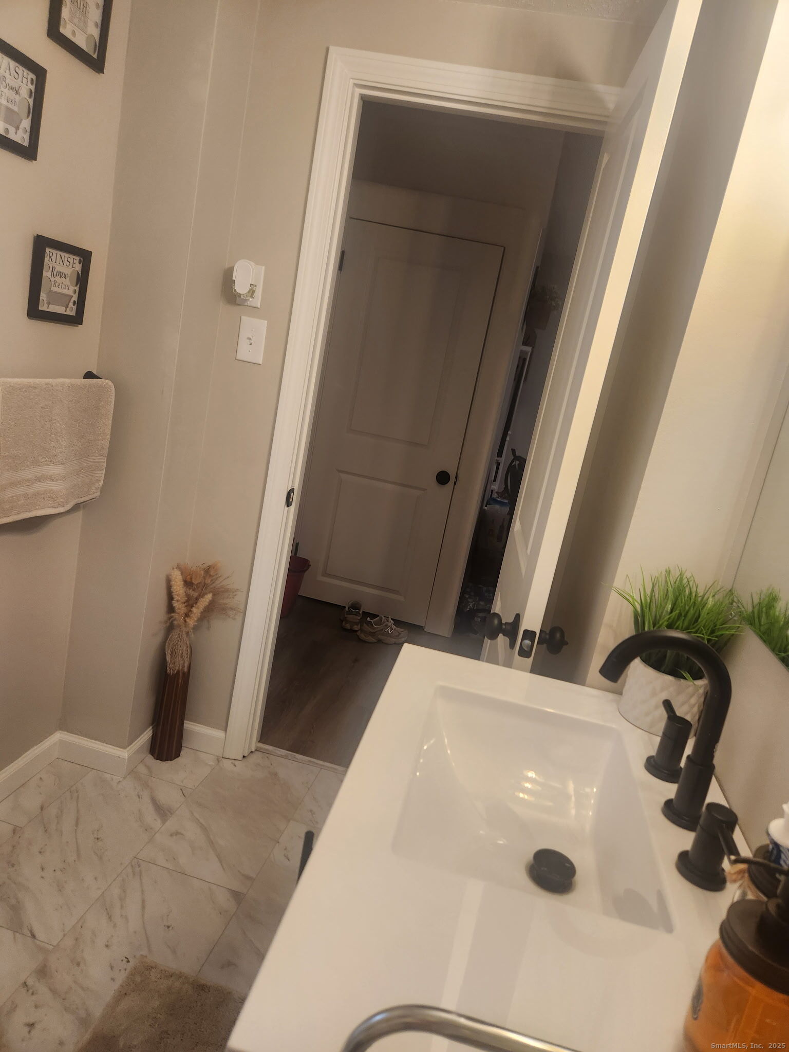 515 Liberty Street, Unit 515 Meriden, CT 06450 - Photo 4 of 11 a bathroom with a sink and a mirror