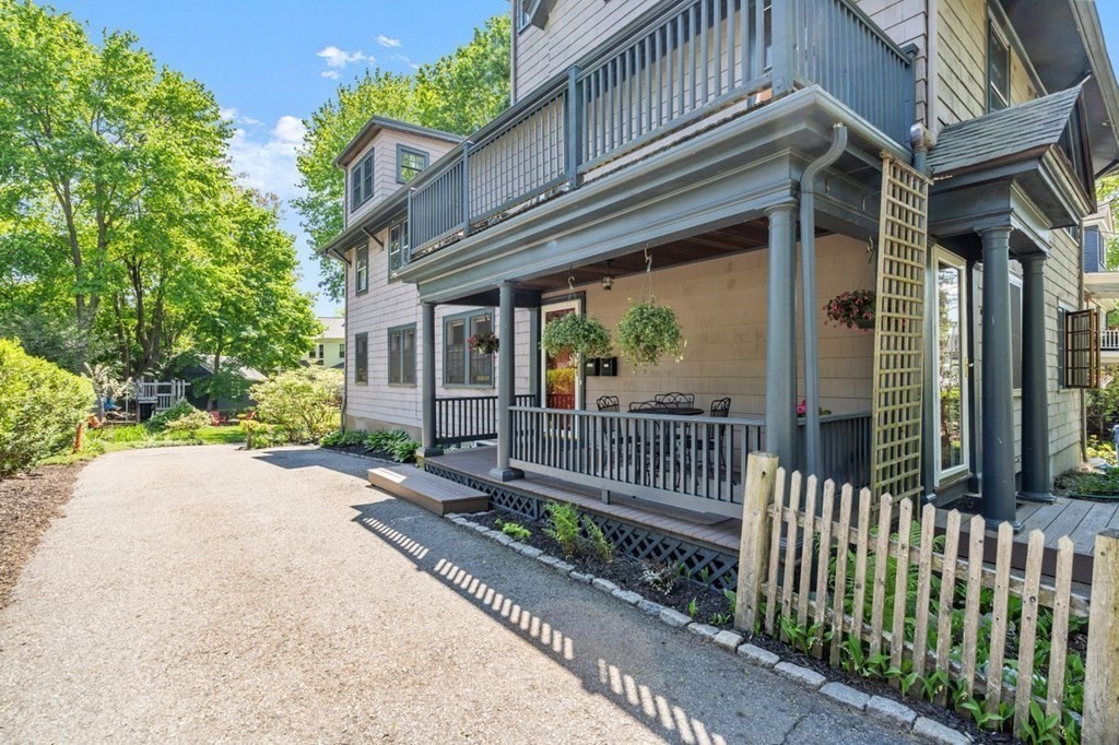 18 Stoneleigh Road, Unit 18 Newton, MA 02465 - Photo 15 of 26 a view of a house with a small yard and wooden fence