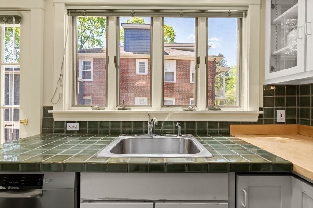 18 Stoneleigh Road, Unit 18 Newton, MA 02465 - Photo 21 of 26 a kitchen with granite countertop a sink and a counter top space