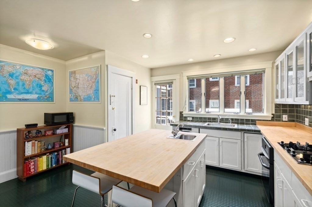 18 Stoneleigh Road, Unit 18 Newton, MA 02465 - Photo 22 of 26 a large kitchen with a table and chairs in it
