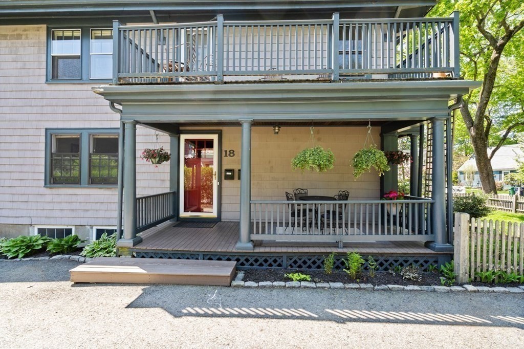 18 Stoneleigh Road, Unit 18 Newton, MA 02465 - Photo 26 of 26 a view of a house with a small yard and wooden floor and fence