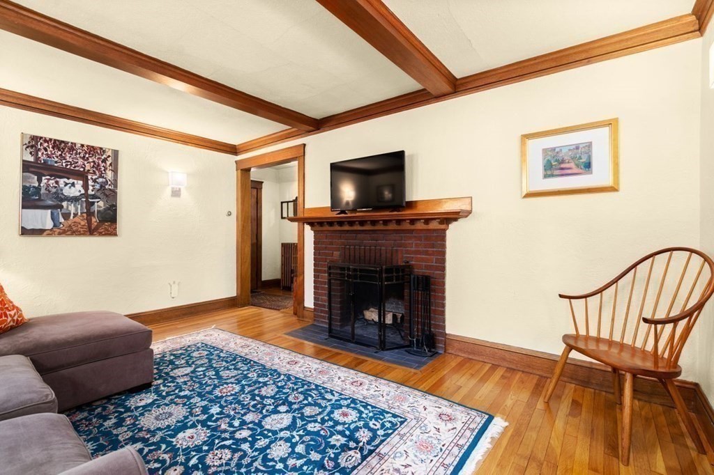 18 Stoneleigh Road, Unit 18 Newton, MA 02465 - Photo 5 of 26 a living room with furniture and a fireplace