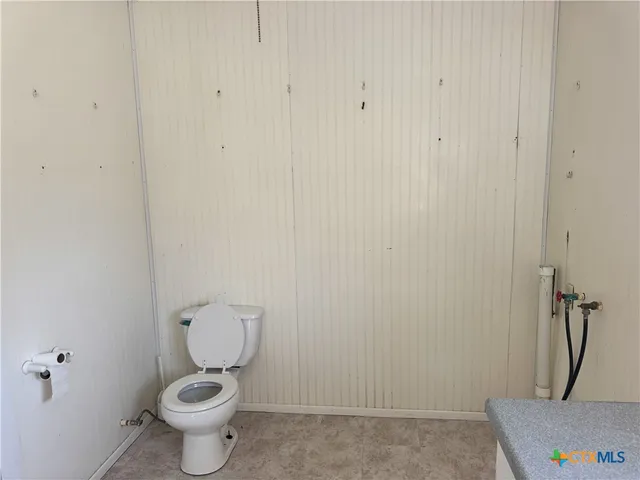 a white toilet sitting next to a sink