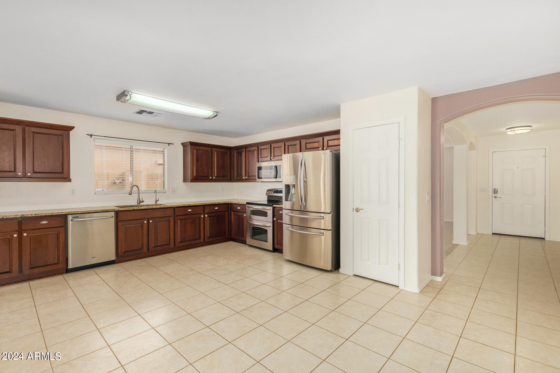 2328 West Carson Road Phoenix, AZ 85041 - Photo 16 of 42 a kitchen with stainless steel appliances a refrigerator and a sink