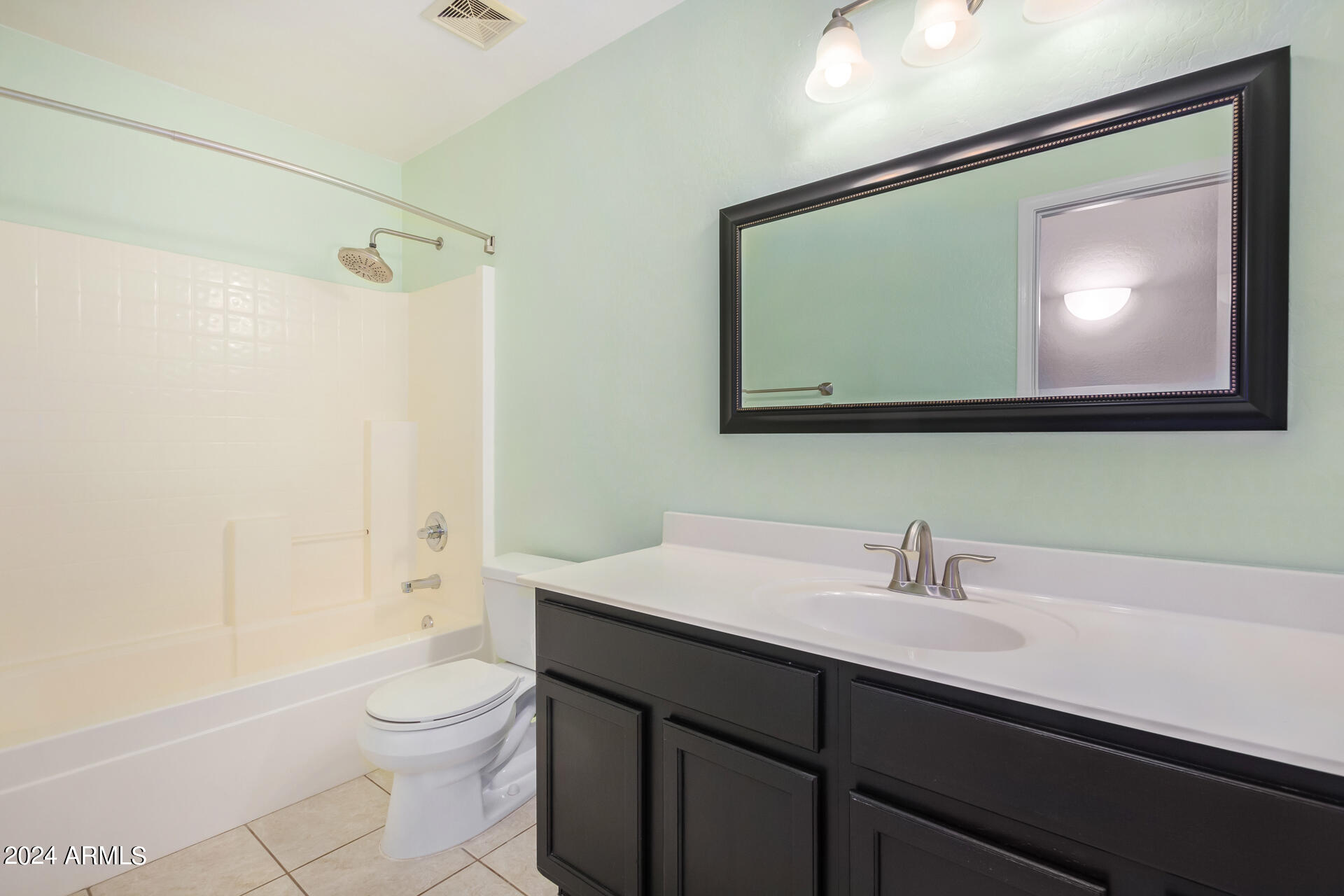 2328 West Carson Road Phoenix, AZ 85041 - Photo 31 of 42 a bathroom with a toilet a sink and mirror