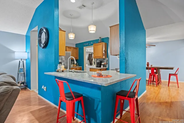 a dining hall with a sink and a stove