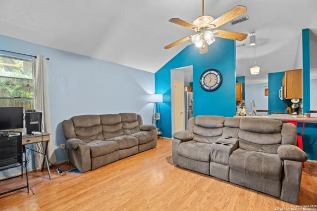 a living room with furniture and a mirror