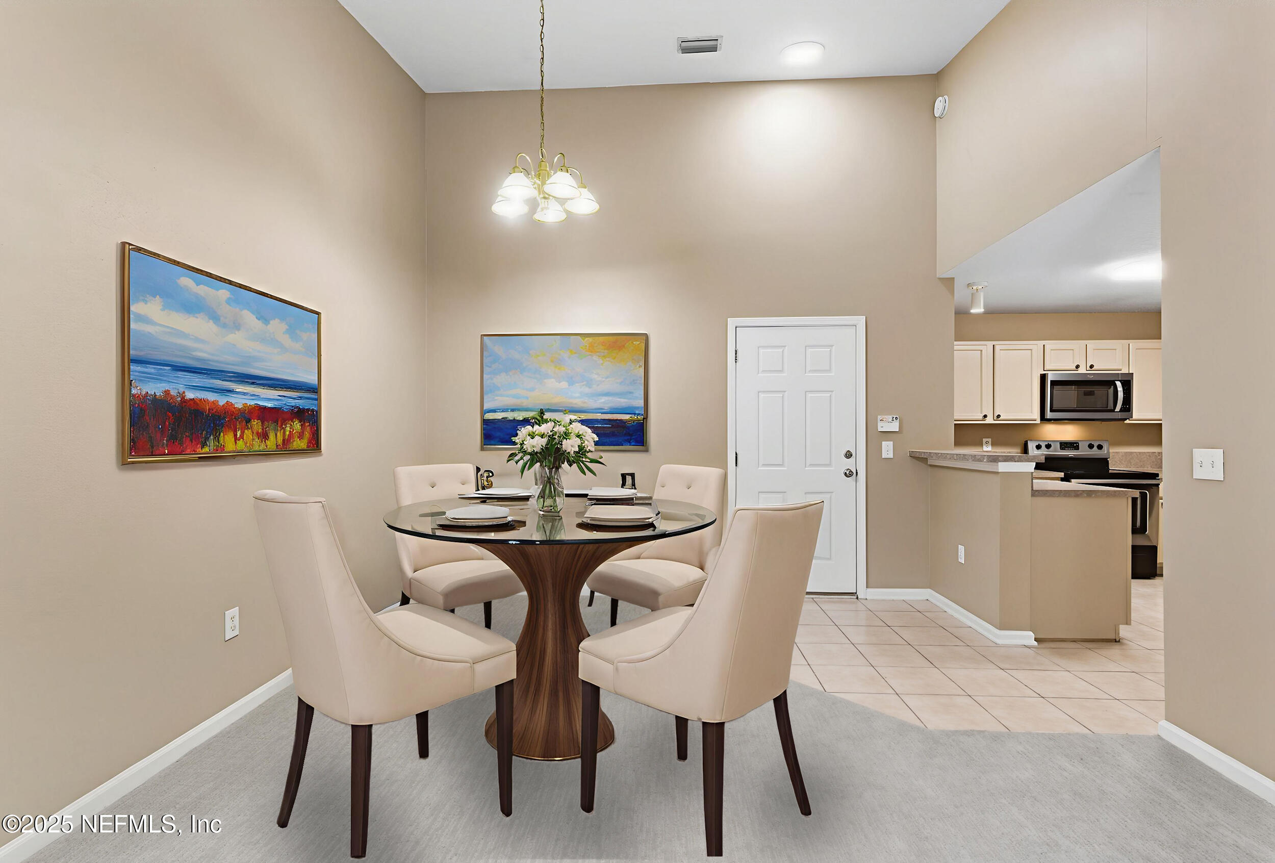 6069 Maggies Circle, Unit 115 Jacksonville, FL 32244 - Photo 12 of 36 a view of a dining room with furniture and chandelier