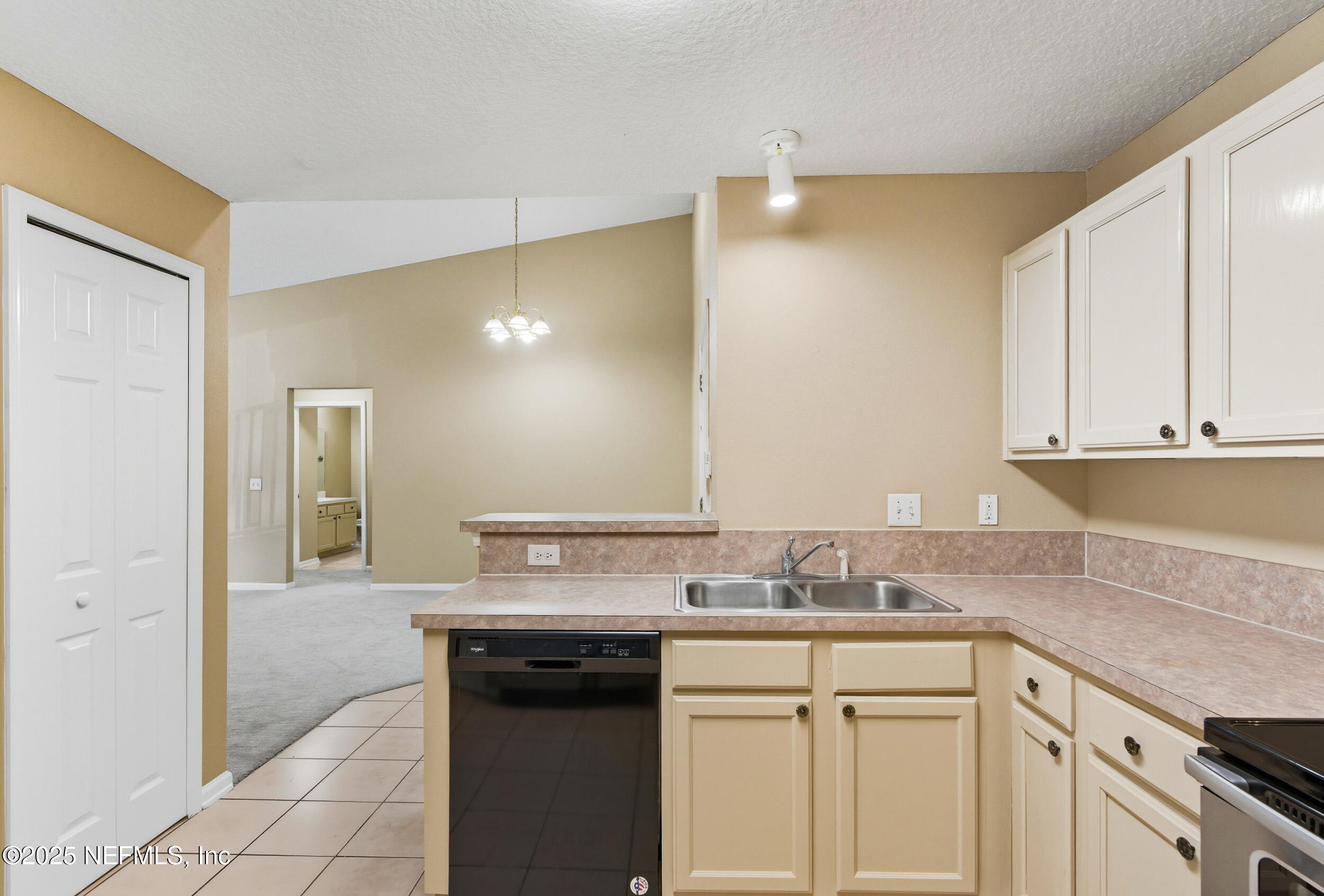 6069 Maggies Circle, Unit 115 Jacksonville, FL 32244 - Photo 14 of 36 a kitchen with granite countertop a sink and cabinets