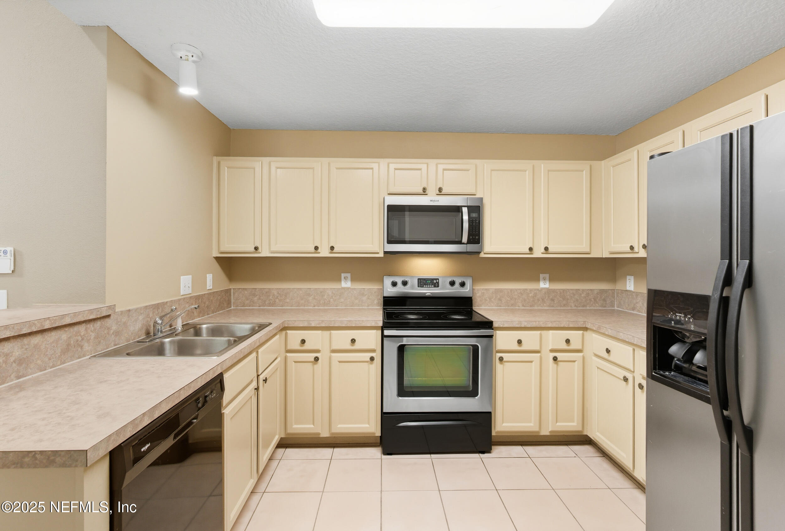 6069 Maggies Circle, Unit 115 Jacksonville, FL 32244 - Photo 16 of 36 a kitchen with a sink appliances and cabinets