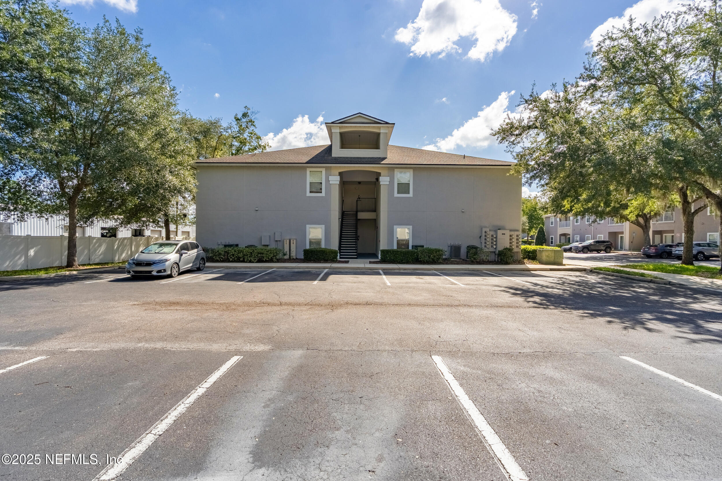 6069 Maggies Circle, Unit 115 Jacksonville, FL 32244 - Photo 2 of 36 a front view of a house with a yard