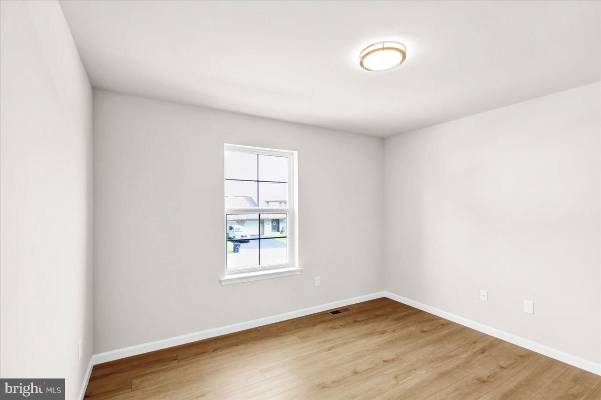 2450 Jefferson Avenue Reading, PA 19609 - Photo 18 of 33 an empty room with wooden floor and windows