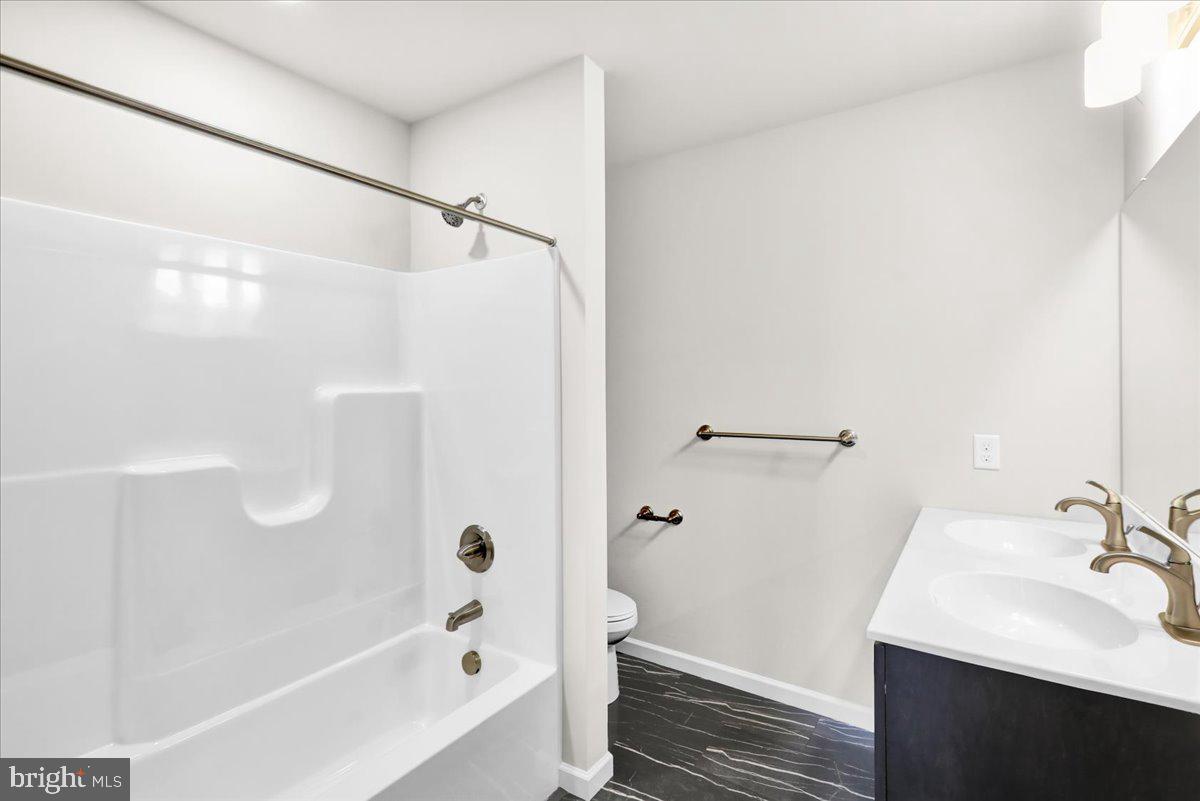 2450 Jefferson Avenue Reading, PA 19609 - Photo 20 of 33 a bathroom with a bathtub shower sink vanity and a toilet