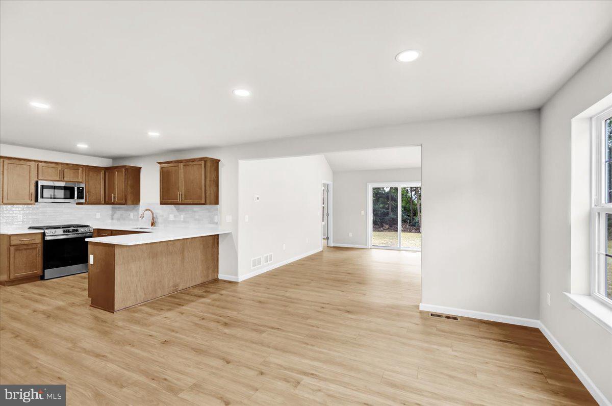 2450 Jefferson Avenue Reading, PA 19609 - Photo 7 of 33 a large kitchen with a center island wooden floor and stainless steel appliances
