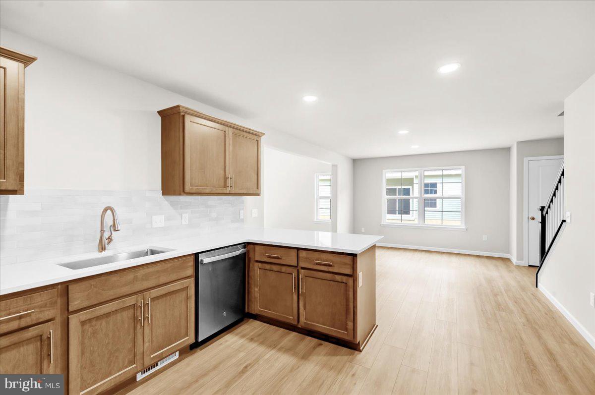 2450 Jefferson Avenue Reading, PA 19609 - Photo 10 of 33 a kitchen with a sink wooden floor and black wooden cabinets