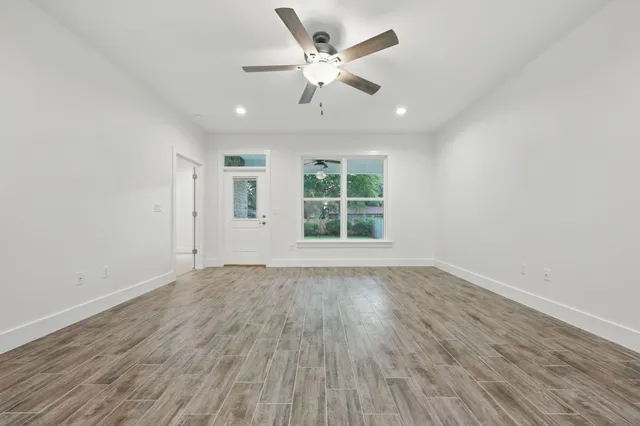 wooden floor in an empty room with a window