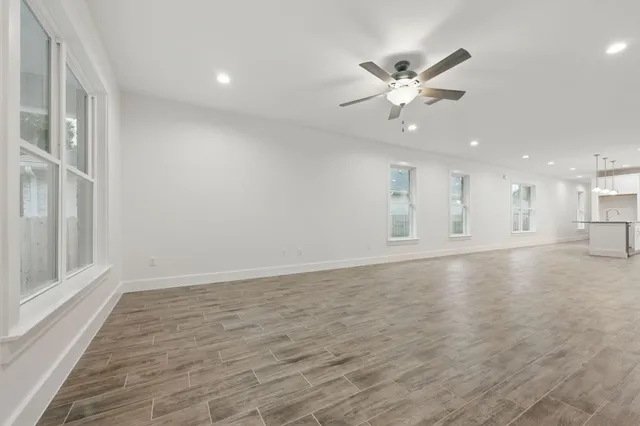 a view of an empty room with a ceiling fan