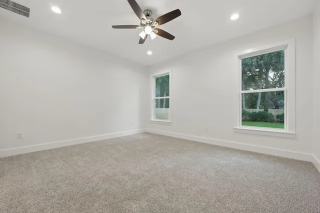 an empty room with fan and a ceiling fan